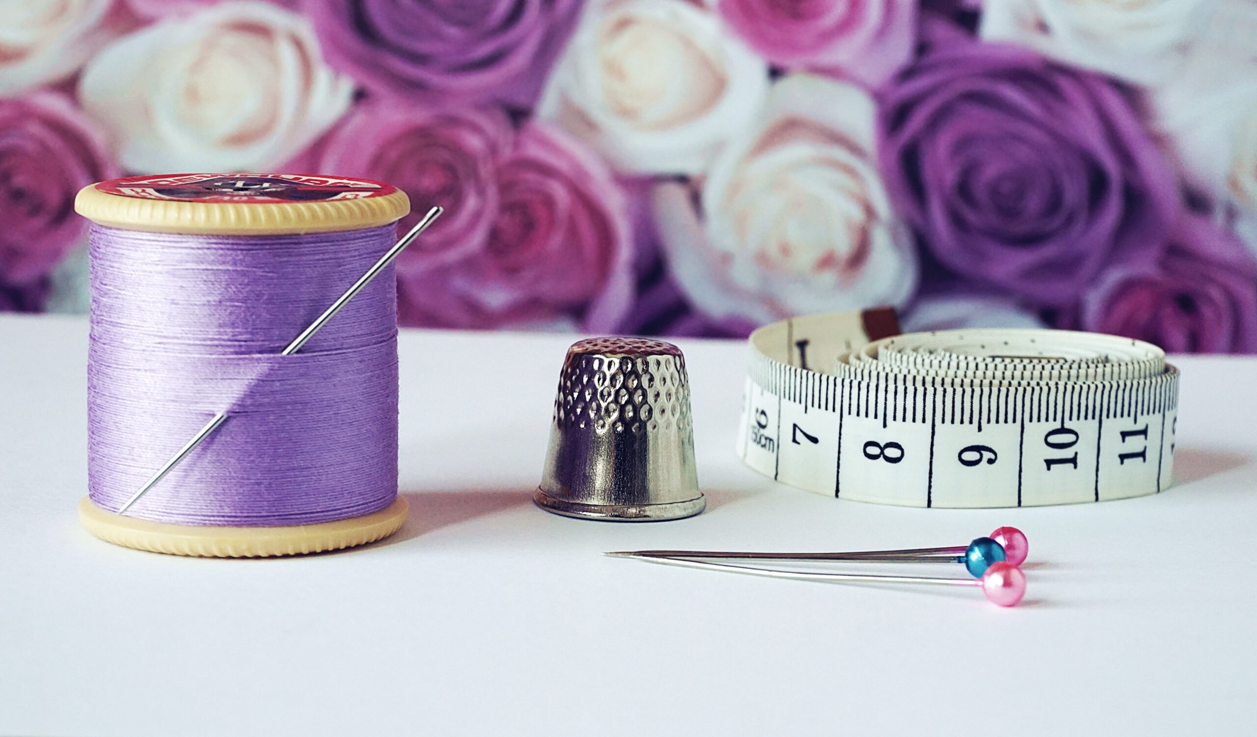 spool-of-purple-thread-needle-thimble